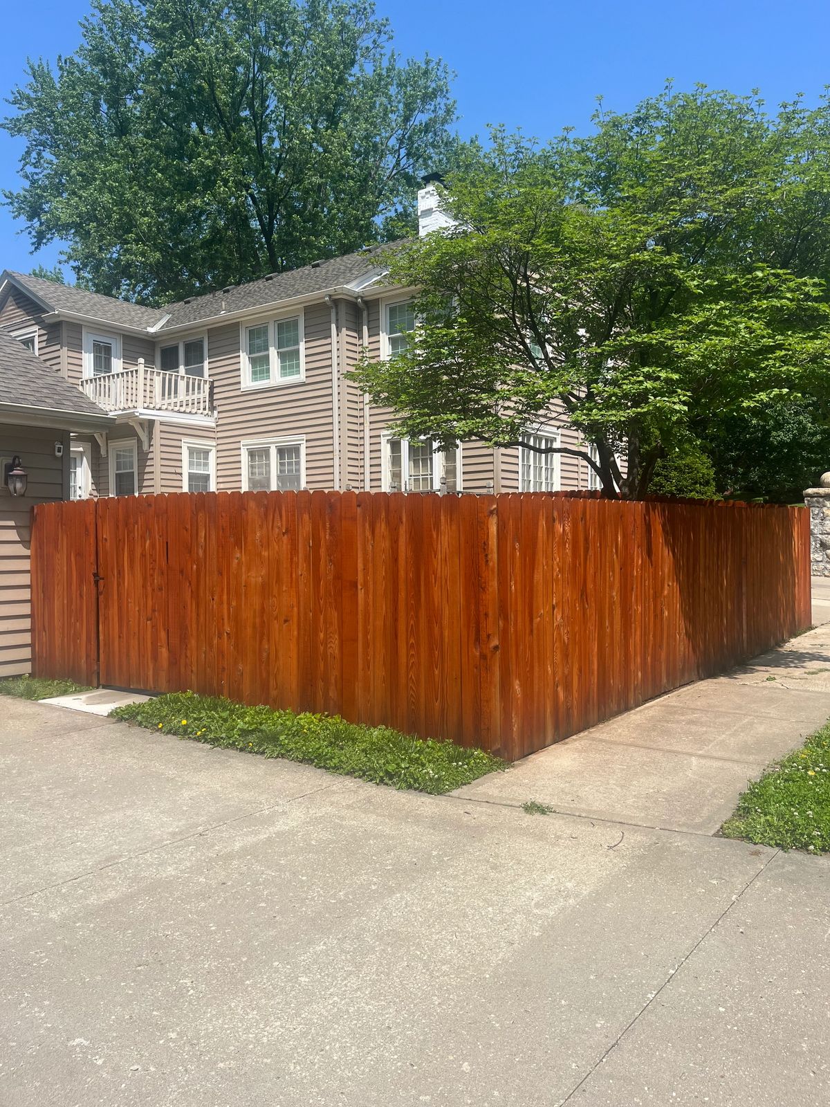 Stained wood privacy fence installed by Bundy Fence